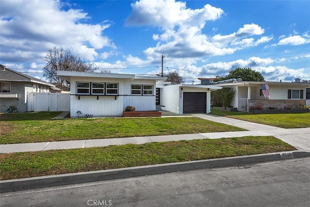 ranch-style home with a garage and a front lawn