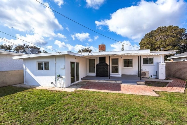 rear view of house featuring a yard, ac unit, and a patio