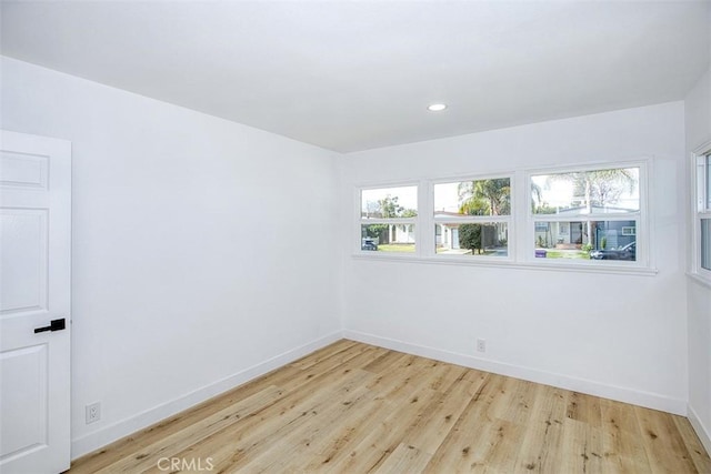 unfurnished room featuring a healthy amount of sunlight and light hardwood / wood-style flooring