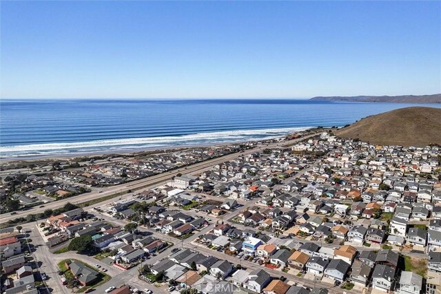 birds eye view of property featuring a water view and a beach view