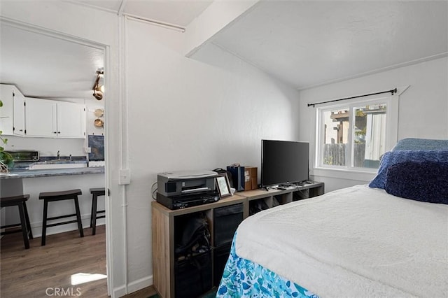 bedroom featuring lofted ceiling and dark hardwood / wood-style floors