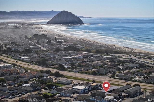 aerial view with a water and mountain view and a beach view