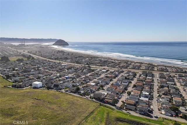 drone / aerial view featuring a view of the beach and a water view