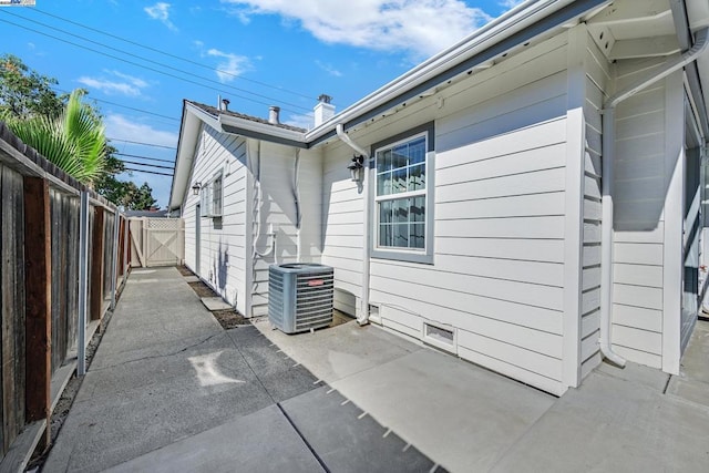 view of property exterior featuring central AC and a patio area