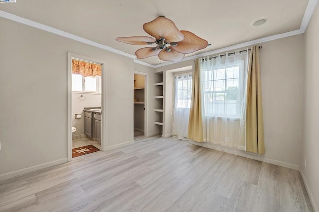 spare room featuring ceiling fan, ornamental molding, and light hardwood / wood-style flooring