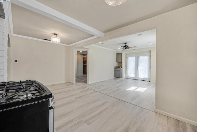 kitchen featuring french doors, gas stove, ornamental molding, and light hardwood / wood-style flooring