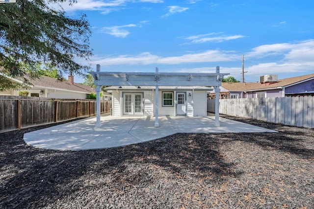 rear view of house featuring central AC unit, a patio, and french doors