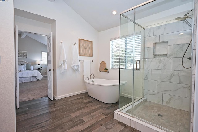 bathroom with lofted ceiling and separate shower and tub