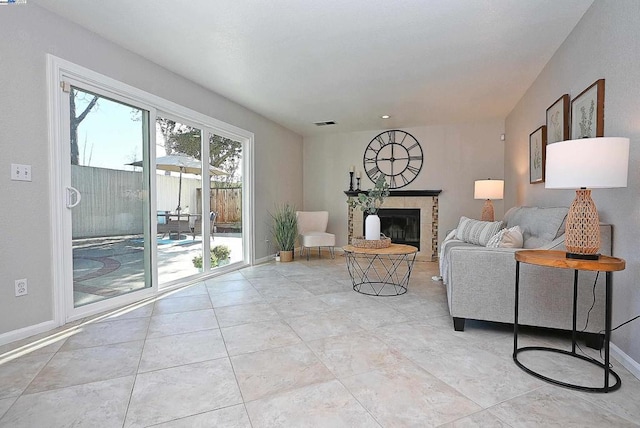 living room with a tiled fireplace