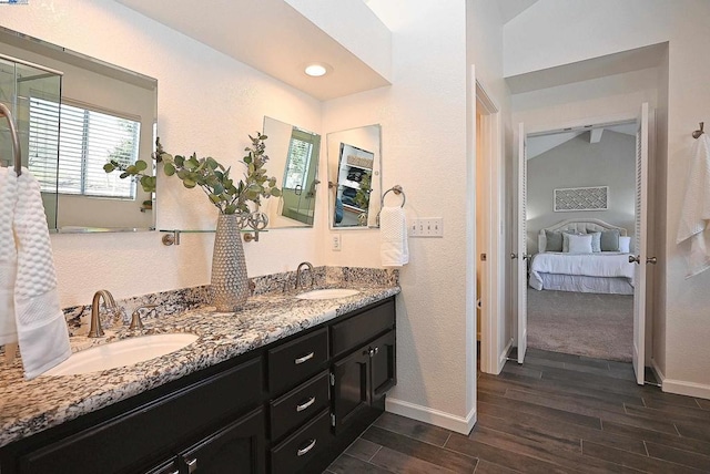 bathroom with vanity and lofted ceiling