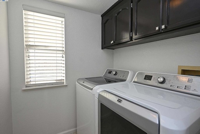 washroom with cabinets and independent washer and dryer