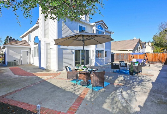 rear view of property featuring a patio, an outdoor hangout area, and central AC