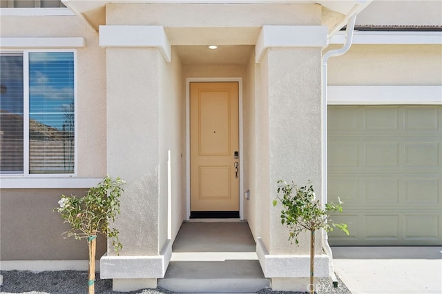 view of exterior entry with a garage