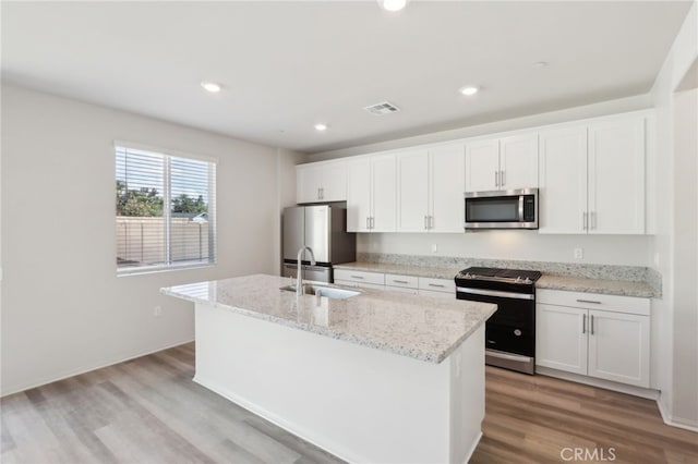 kitchen with sink, a center island with sink, white cabinets, and appliances with stainless steel finishes