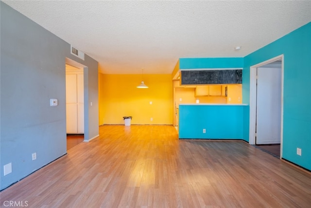 spare room with wood-type flooring and a textured ceiling