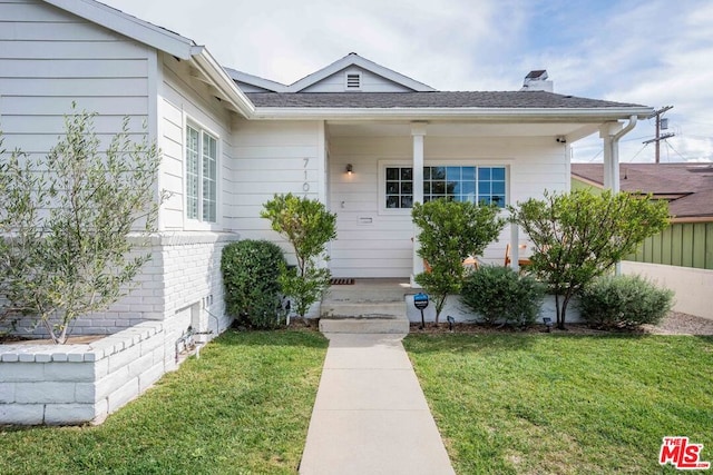 doorway to property with a yard