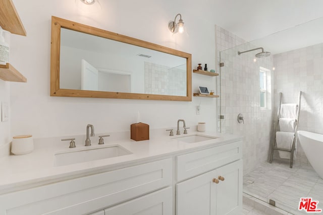 bathroom with independent shower and bath and vanity