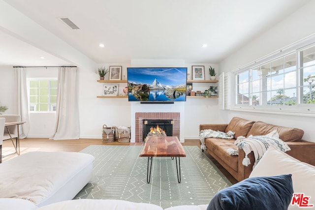 living room with hardwood / wood-style floors and a fireplace