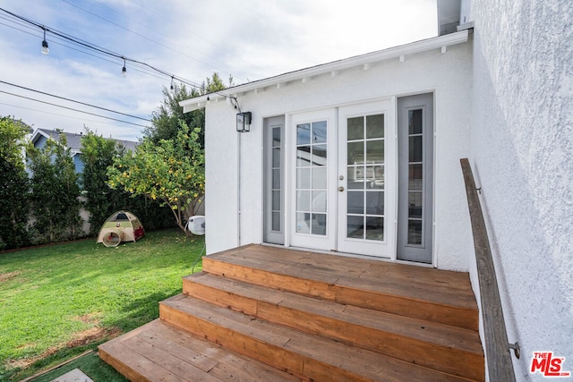 doorway to property featuring a yard