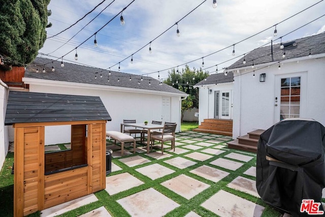 view of patio featuring area for grilling and an outbuilding