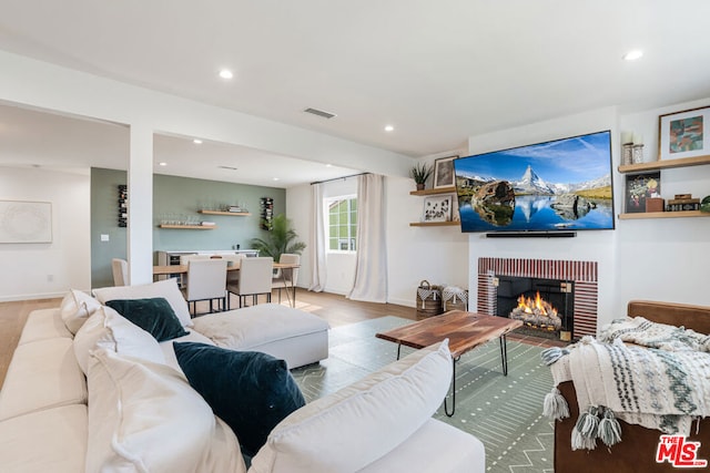 living room featuring a fireplace and light wood-type flooring