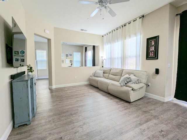 living room with ceiling fan and hardwood / wood-style floors