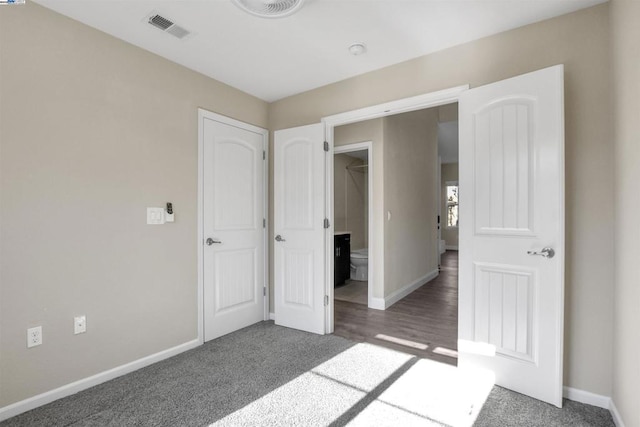 unfurnished bedroom featuring dark colored carpet