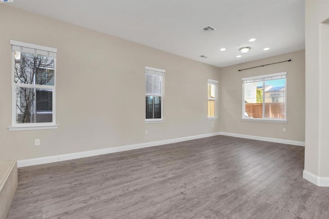 spare room with dark hardwood / wood-style flooring