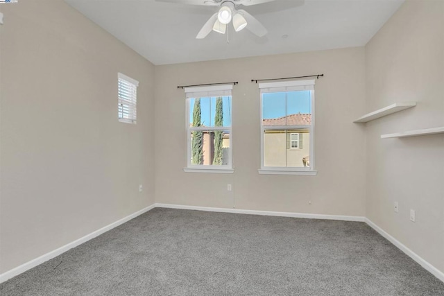 carpeted empty room featuring ceiling fan