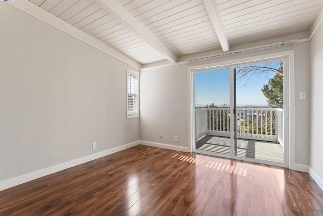 spare room featuring dark hardwood / wood-style floors and beamed ceiling