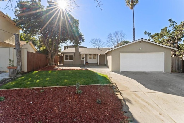 view of front of house featuring a garage and a front lawn