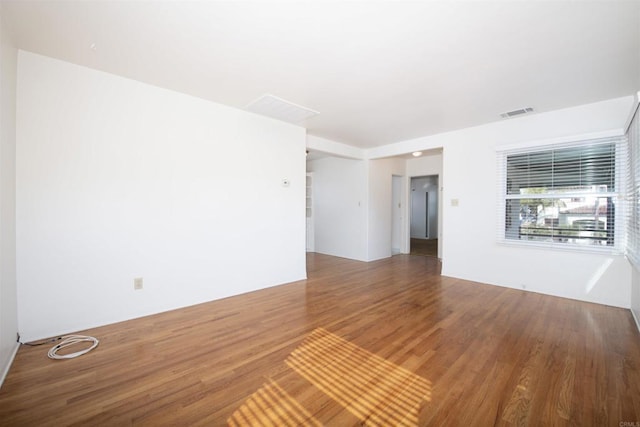 spare room featuring wood-type flooring