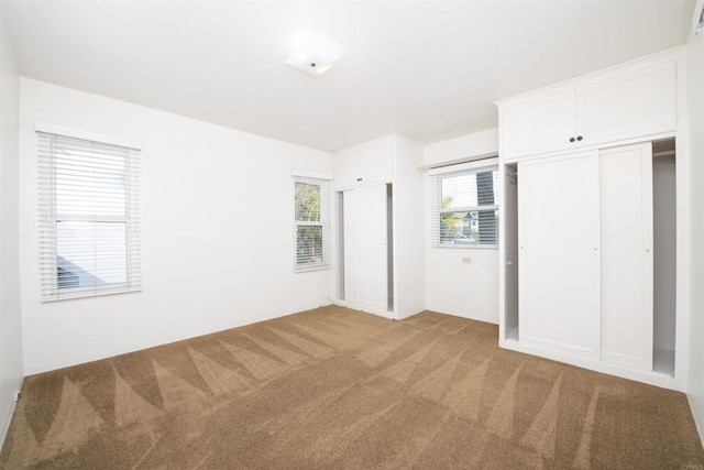 unfurnished bedroom with light carpet