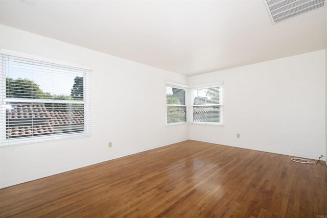 unfurnished room with hardwood / wood-style floors