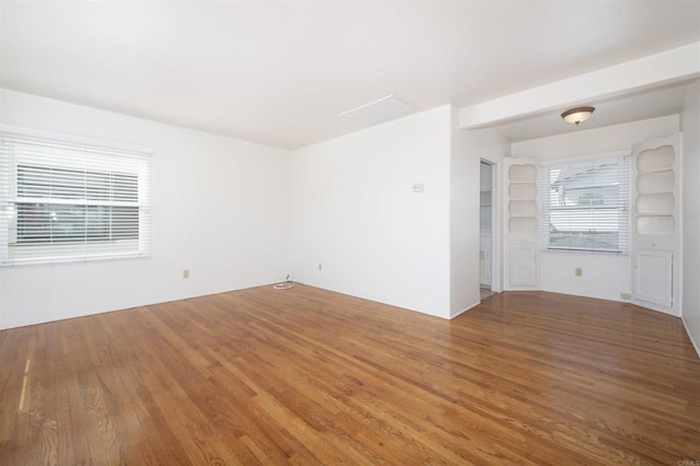 unfurnished room featuring hardwood / wood-style floors