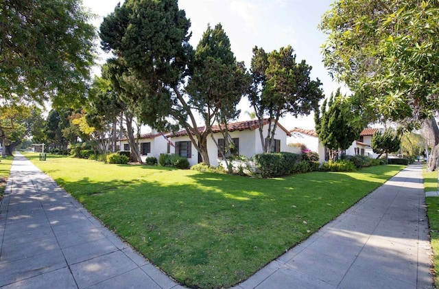 mediterranean / spanish house with a front yard