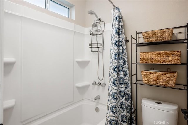 bathroom with shower / tub combo with curtain and toilet