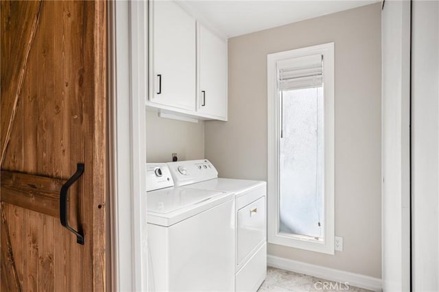 washroom with cabinets and washing machine and clothes dryer