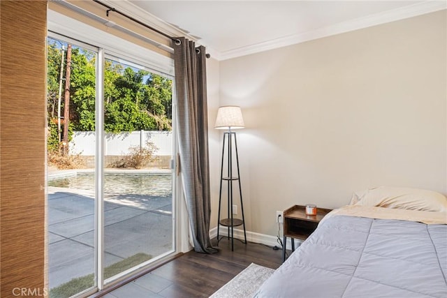 bedroom with crown molding, dark wood-type flooring, and access to outside