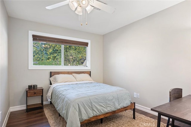 bedroom with dark wood-type flooring and ceiling fan