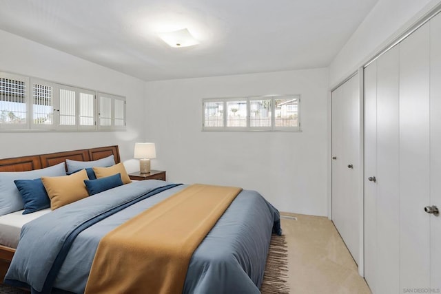 bedroom with light colored carpet and a closet