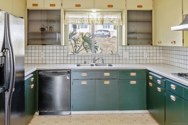 kitchen featuring sink, backsplash, and black appliances