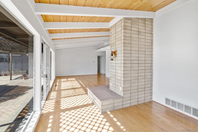 interior space with vaulted ceiling with beams, wood ceiling, and light hardwood / wood-style flooring