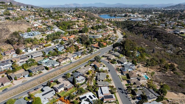 drone / aerial view with a water and mountain view