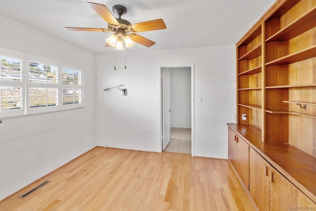 spare room featuring ceiling fan and light hardwood / wood-style floors