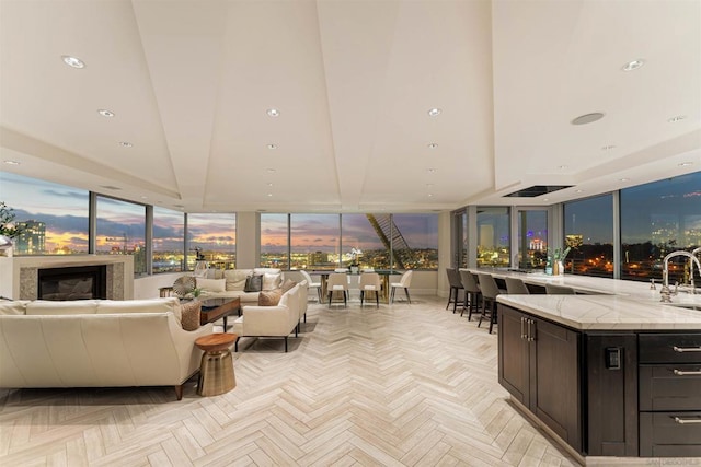 living room featuring light parquet flooring and sink