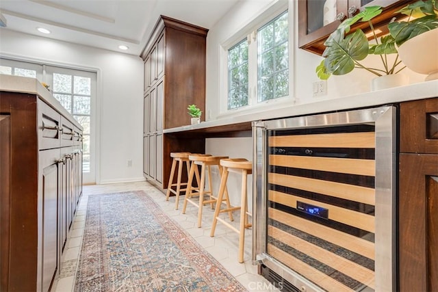 interior space featuring wine cooler and light tile patterned flooring