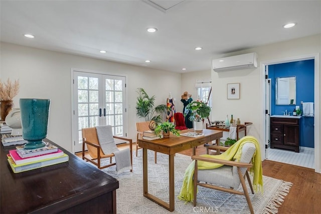 dining room featuring french doors, a wall mounted AC, and light wood-type flooring