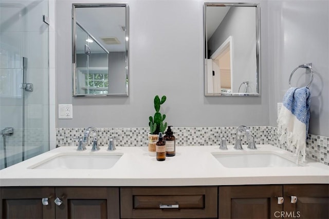 bathroom with a shower with door and vanity