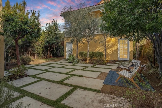 patio terrace at dusk featuring an outdoor structure